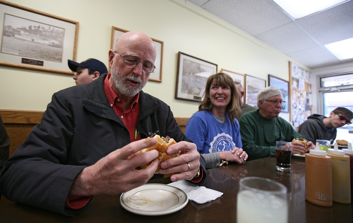 Ralph Kerr reacts after taking the first bite of his first Huddy Burger as friend LaDonna Beaumont takes in the scene Friday in Hudson's Hamburgers.