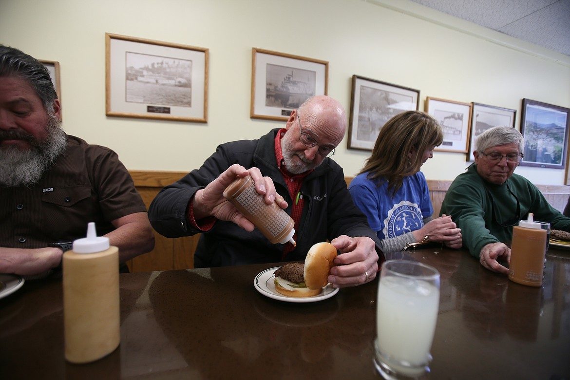 Ralph Kerr goes all in as he sauces his first Huddy Burger on Friday. "This looks like a real genuine hamburger," Kerr said.
