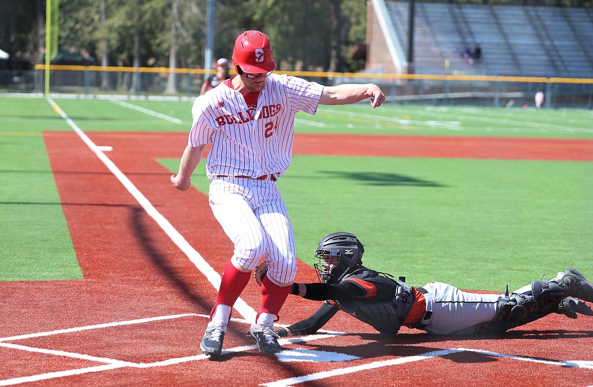 Junior Ethan Butler gets tagged out while crossing home plate on Saturday.