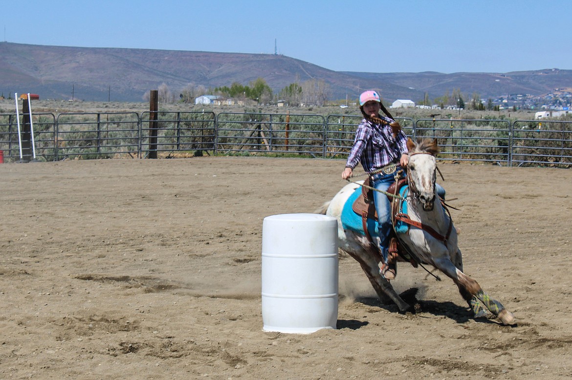 Alyssa Howe rounds a barrel at the Washington State Horsemen show day on Saturday.