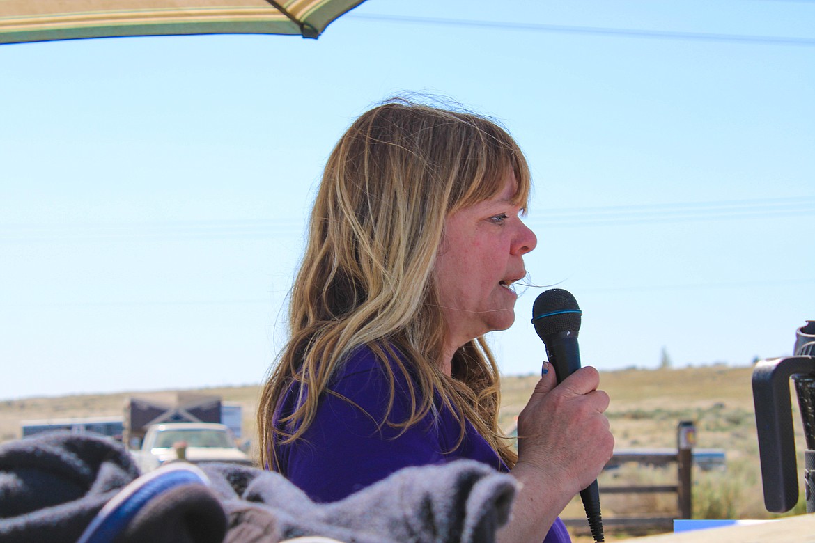 Maria Howe, show chair, announces race time at the Washington State Horsemen show day on Saturday.