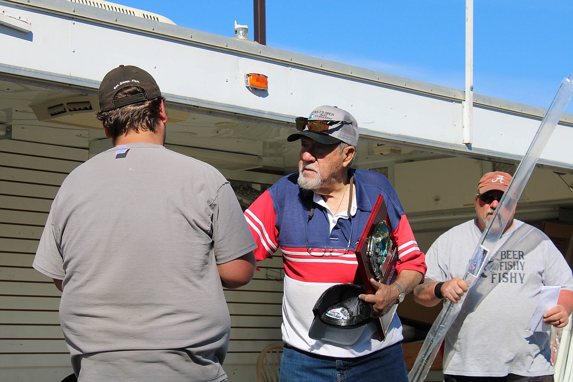 Ben Sims of Wenatchee accepts the first place plaque from Potholes Bass Club treasurer Merle Armstrong at the 41st Potholes Open on Sunday.