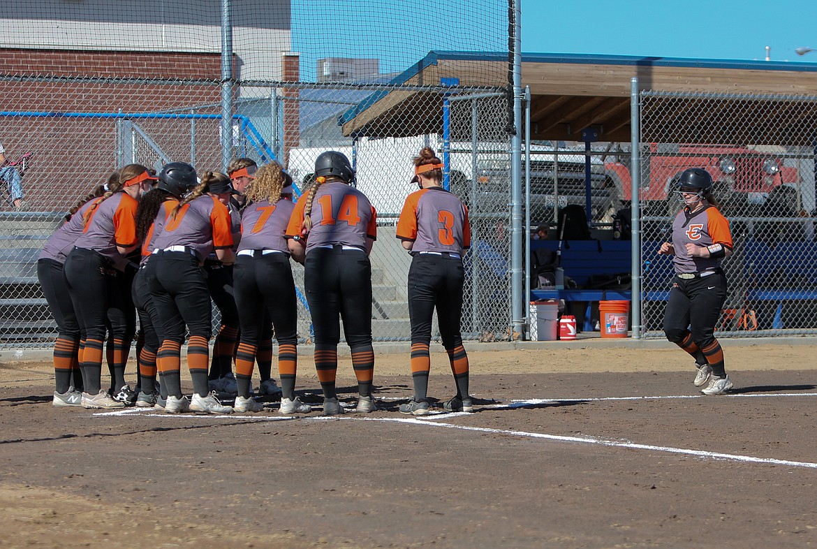 Ephrata High School softball players wait at home plate to celebrate with Kylar Heston (10) after knocking a home run on Friday afternoon at Warden High School.