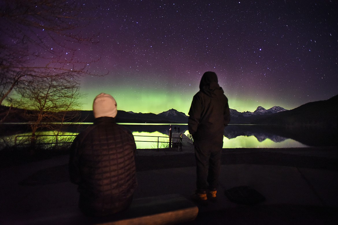 A group of visitors take in the aurora borealis lighting up the skies over Lake McDonald inside Glacier National Park. (Jeremy Weber/Daily Inter Lake)