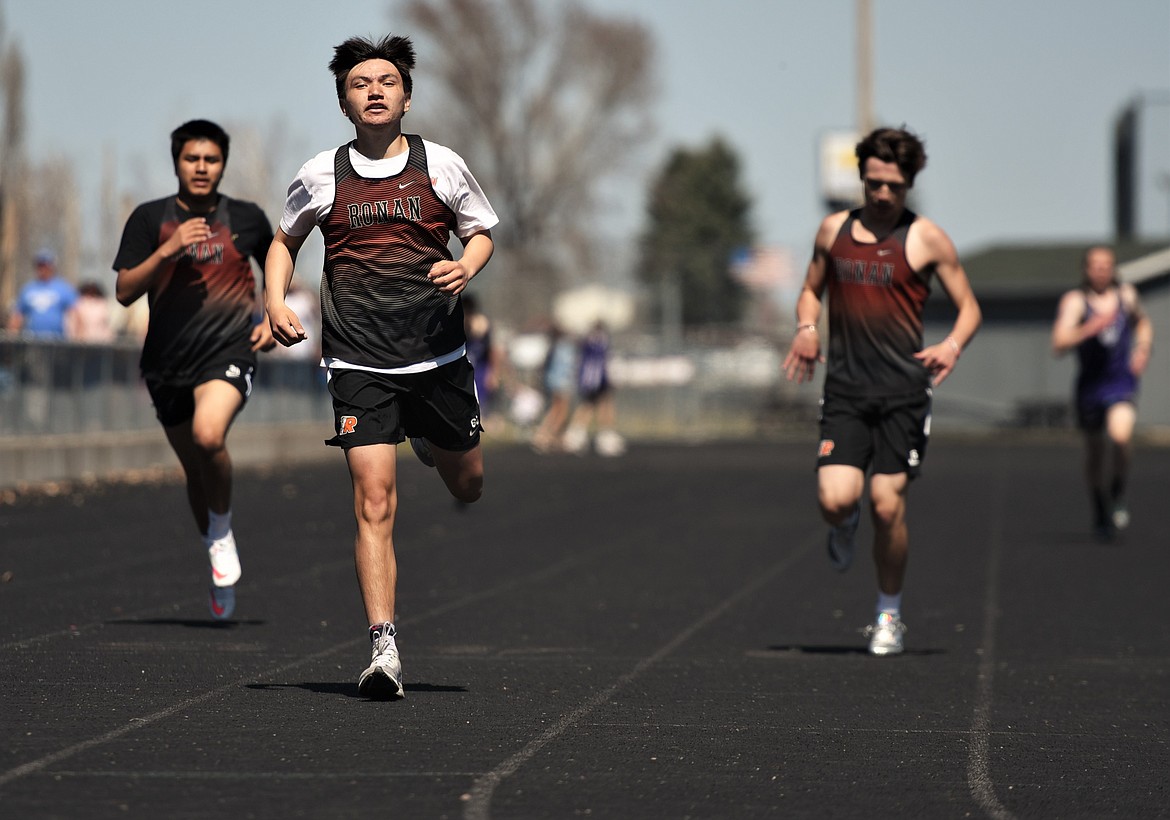 Ronan runners, from left, Josiah Long, Jordan Gatch and Trenton Burland head toward the finish in the boys 400 meters Saturday. (Scot Heisel/Lake County Leader)