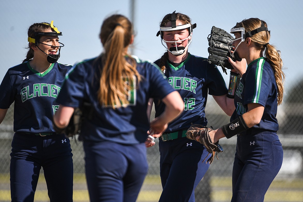 From left, Glacier's Avery Anderson (16), Kenadie Goudette (20), Ella Farrell (12) and Sammie Labrum (10) celebrate after the Wolfpack's 4-0 win over Flathead in the first game of a crosstown doubleheader at Kidsports Complex on Tuesday. (Casey Kreider/Daily Inter Lake)