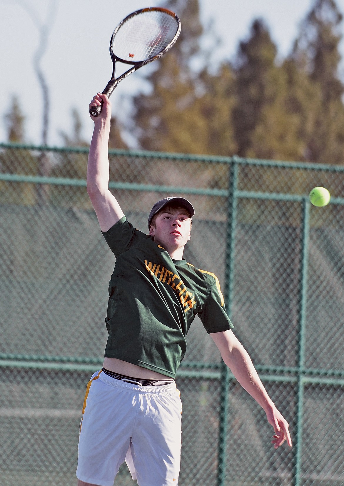 Bulldog Aaron Dicks plays in a doubles match against Havre on Saturday at FVCC. (Whitney England/Whitefish Pilot)