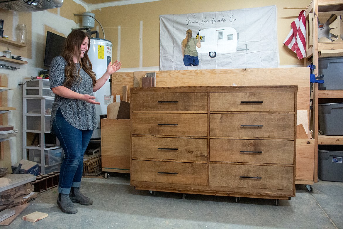 Nicole Case showcases a dresser she recently completed for an expecting coworker's nursery in her garage beside her home in Moses Lake on Tuesday afternoon.