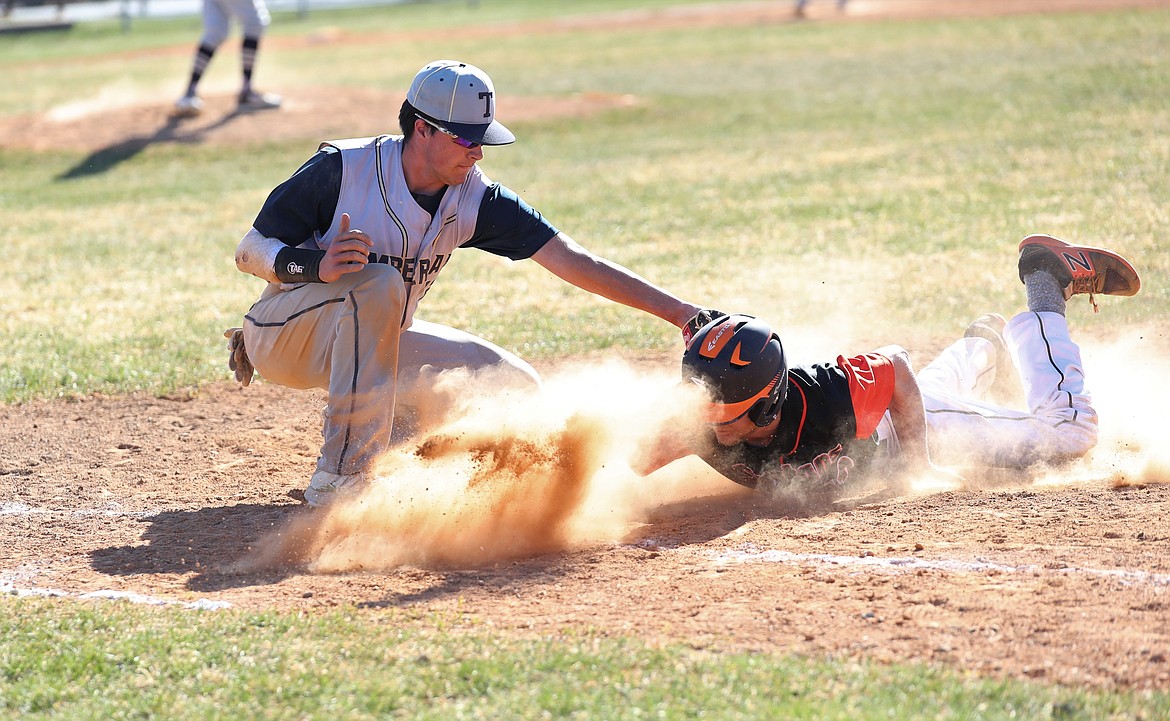 Brendan Reeves slides into first base to avoid being picked off on Friday against Timberlake.