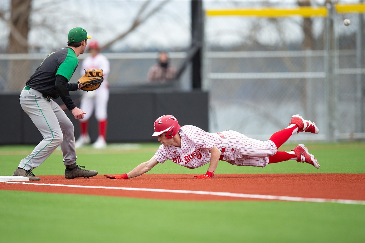 Cameron Garcia dives back to first base to avoid being picked off on Thursday.