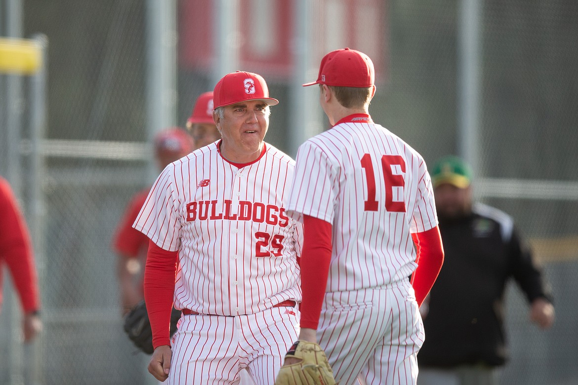 Hitting coach Jason Thielbahr (left) celebrates with Kody MacDonald after he closes out the doubleheader sweep on Thursday.