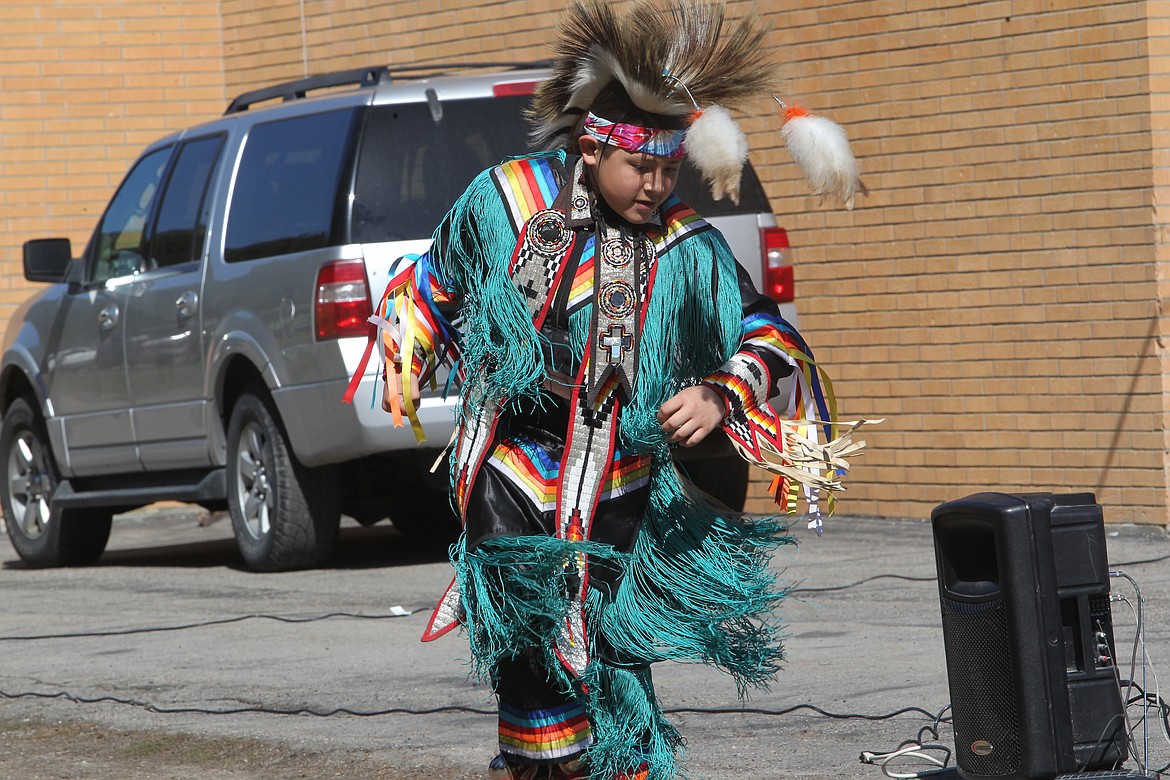 Justice Cree Jr. demonstrates a grass dance to Libby Elementary School students on April 21. American Indians representing the Blackfeet, Cree and Gros Ventre visited the school to share some of their culture and regalia with students. (Will Langhorne/The Western News)