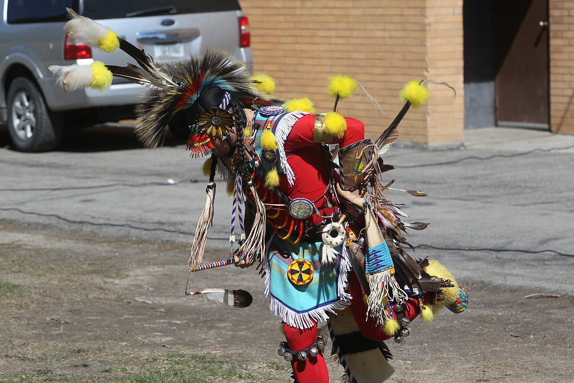 Rod First Strike demonstrates a prairie chicken dance to Libby Elementary School students on April 21. American Indians representing the Blackfeet, Cree and Gros Ventre visited the school to share some of their culture and regalia with students. (Will Langhorne/The Western News)
