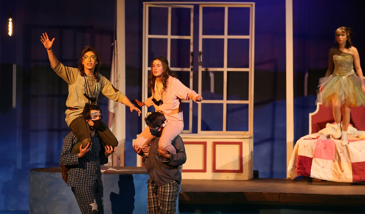 Peter Pan (Harry Blackstone) teaches Wendy (Kaia Poorboy) to fly during a dress rehearsal of "Peter/Wendy" in the Coeur d'Alene High School auditorium on Tuesday. The show runs through May 1.