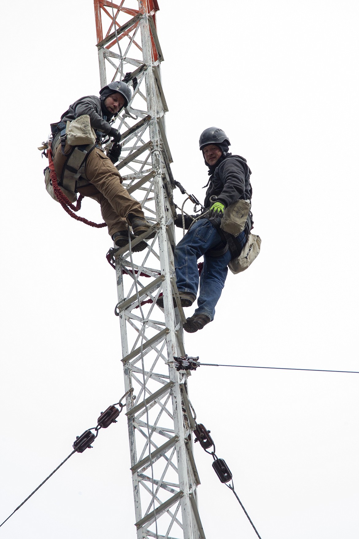 Ben Bakken and Sam Sheppard climb the KWAL radio tower to start their work.