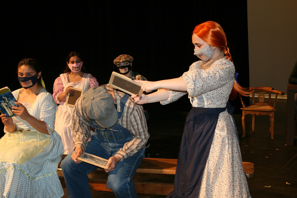 Anne Shirley (Emma Foley, right) gives Gilbert Blythe (Rami Escure, left, standing in for another actor) what he deserves in the Quincy High School production of "Anne of Green Gables."