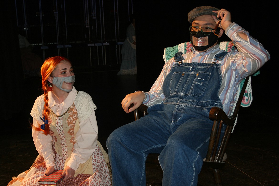 Matthew Cuthbert (Dave Sulisto, right) tries to answer questions from Anne (Emma Foley, left) in the Quincy High School production of "Anne of Green Gables."