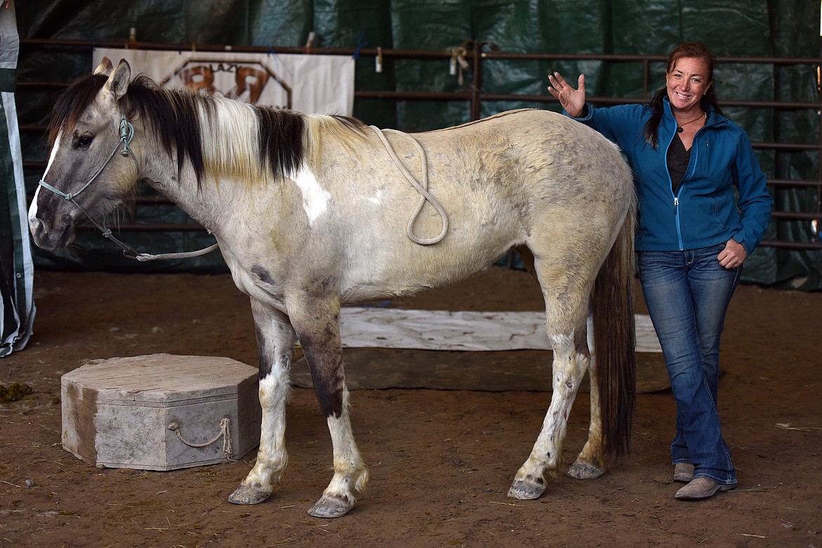 Horse trainer Stacia Stevens shows off her progress Saturday with Champagne on Ice, the horse she is working with for the Extreme Mustang Makeover challenge. Stevens had only been working with the wild horse for four days. (Jeremy Weber/Daily Inter Lake)