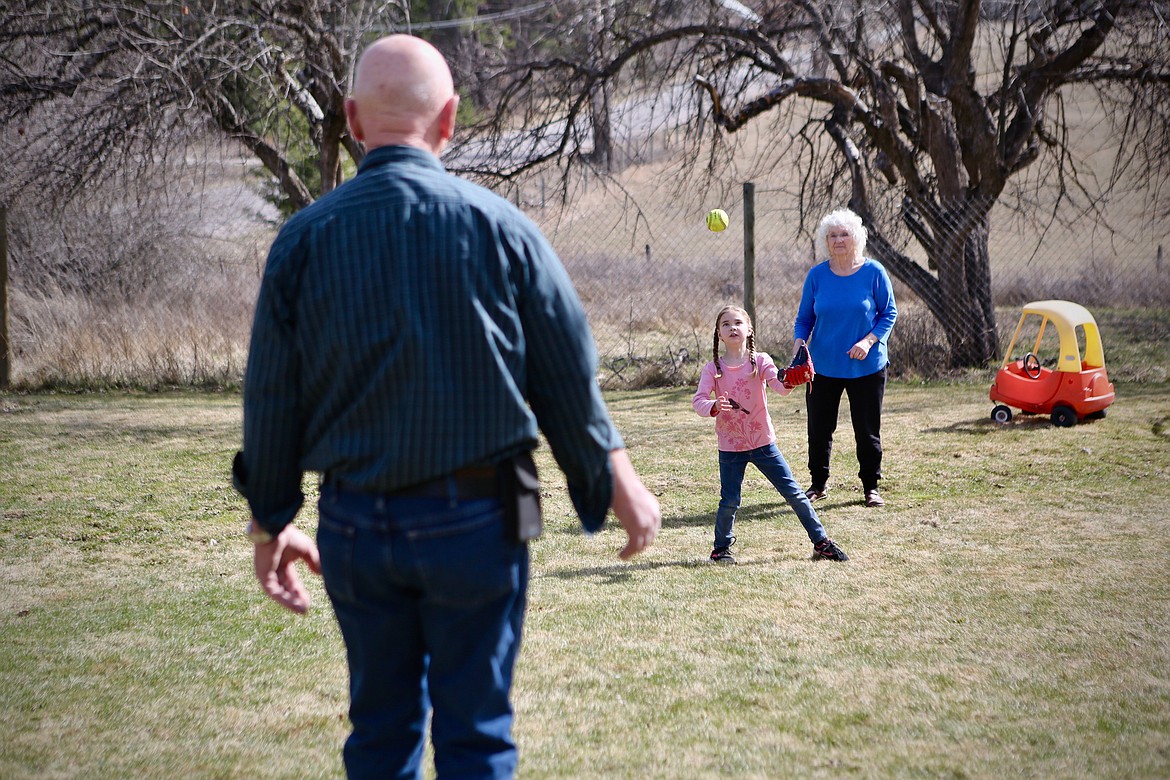 Mavis and Jim Meyer, play catch with their soon-to-be-adopted daughter, Annabella, 7, at their Ferndale home. 
Mackenzie Reiss/Daily Inter Lake