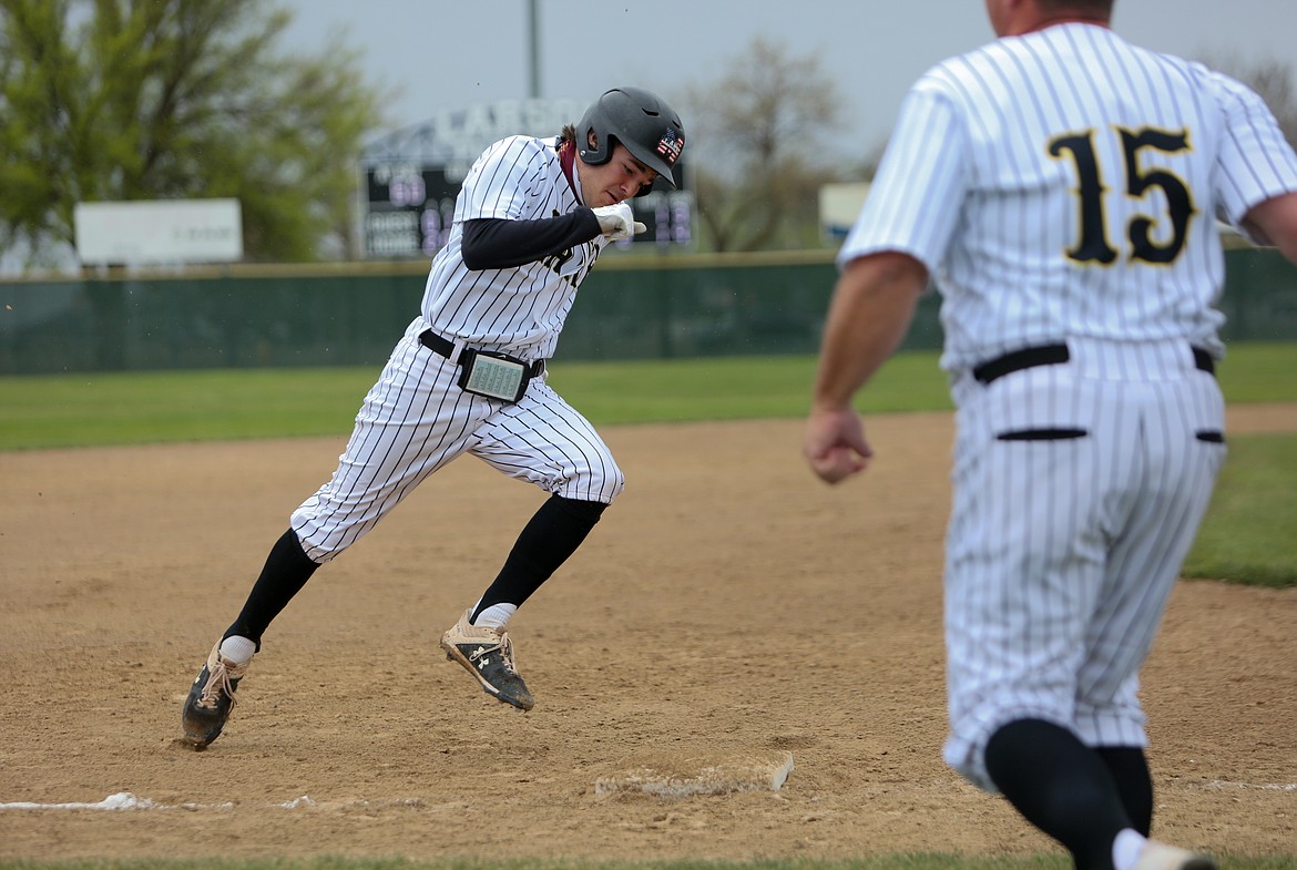 Moses Lake High School's Jackson Purcell rounds third base as he heads toward home to score against Brewster High School on Saturday in Moses Lake.