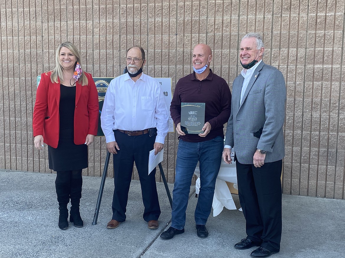 From the left: Washington Food Industry Association President and CEO Tammie Hetrick is joined by Dale Baker, of URM Stores, John Akins Sr., of Akins Fresh Market, and Ray Sprinkle, of URM Stores, to present Akins with WFIA’s 2020-21 Retailer of the Year Award. The presentation was a surprise ceremony held April 6 at Akins Fresh Market in Quincy.