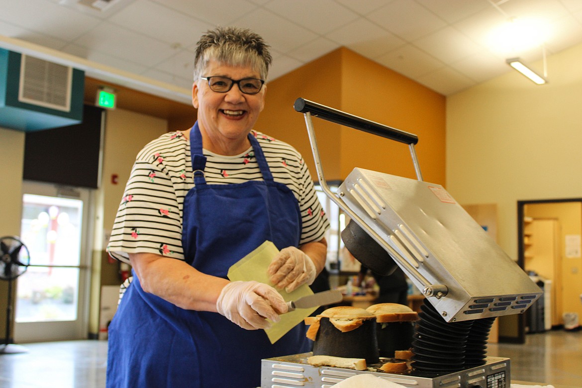 Spokane resident Ladawn Garwood, former Moses Lake Lioness Club member, has been making spaceburgers for decades. Here she is volunteering at the Spaceburger Fest at the Moses Lake Boys & Girls Club on Saturday.