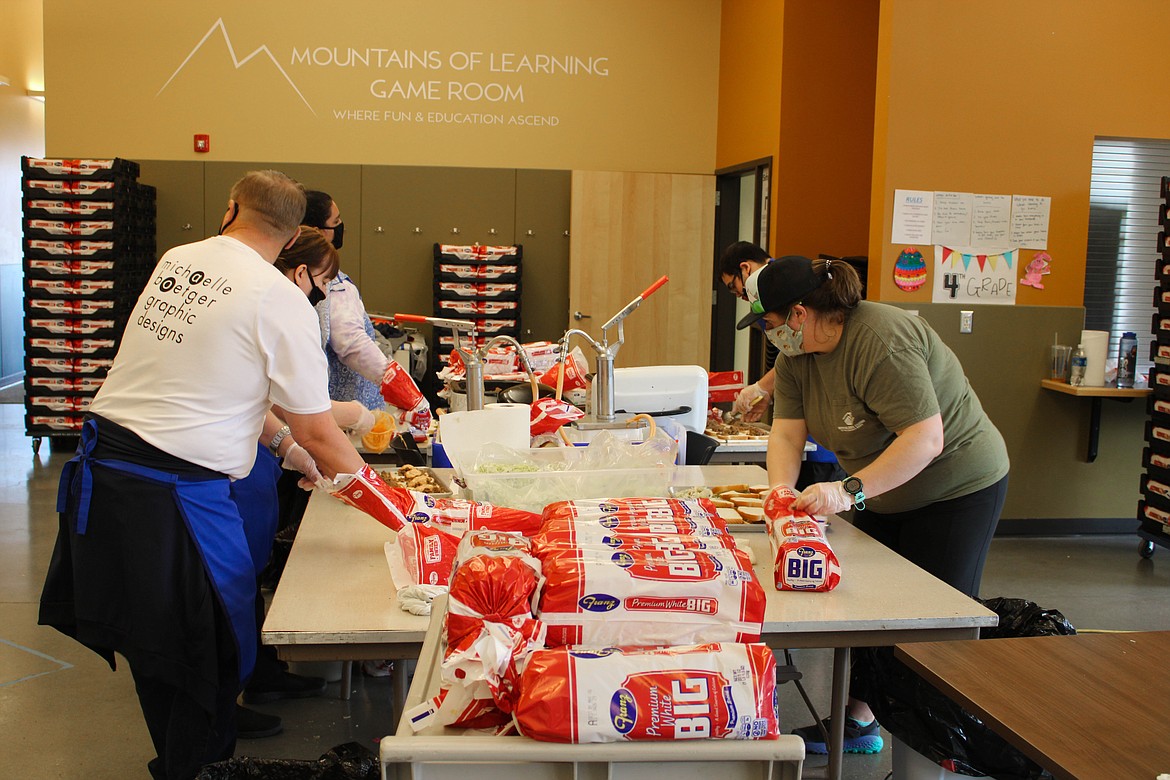 Moses Lake Boys & Girls Club volunteers cook spaceburgers for the Spaceburger Fest on Saturday.