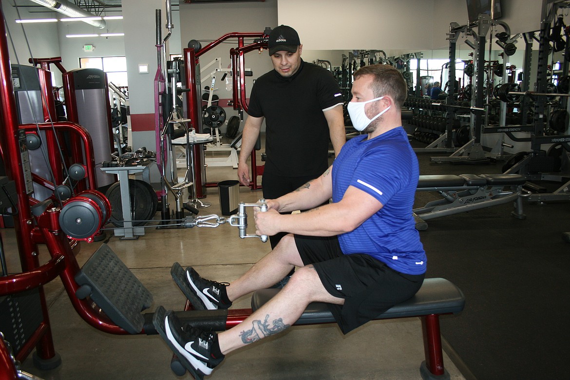 Francisco Quintana (left), trainer at Evolve Fitness, and manager Dale Kemper demonstrate proper exercise posture at the center, at 847 E. Broadway Ave., Moses Lake, No. 11.