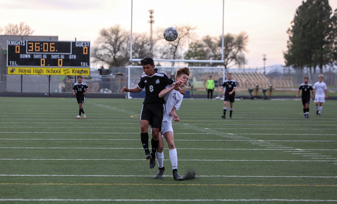 Royal High School's Josue Rodriguez goes up for a header against the Wenatchee player in the first half on Friday night at Royal High School.