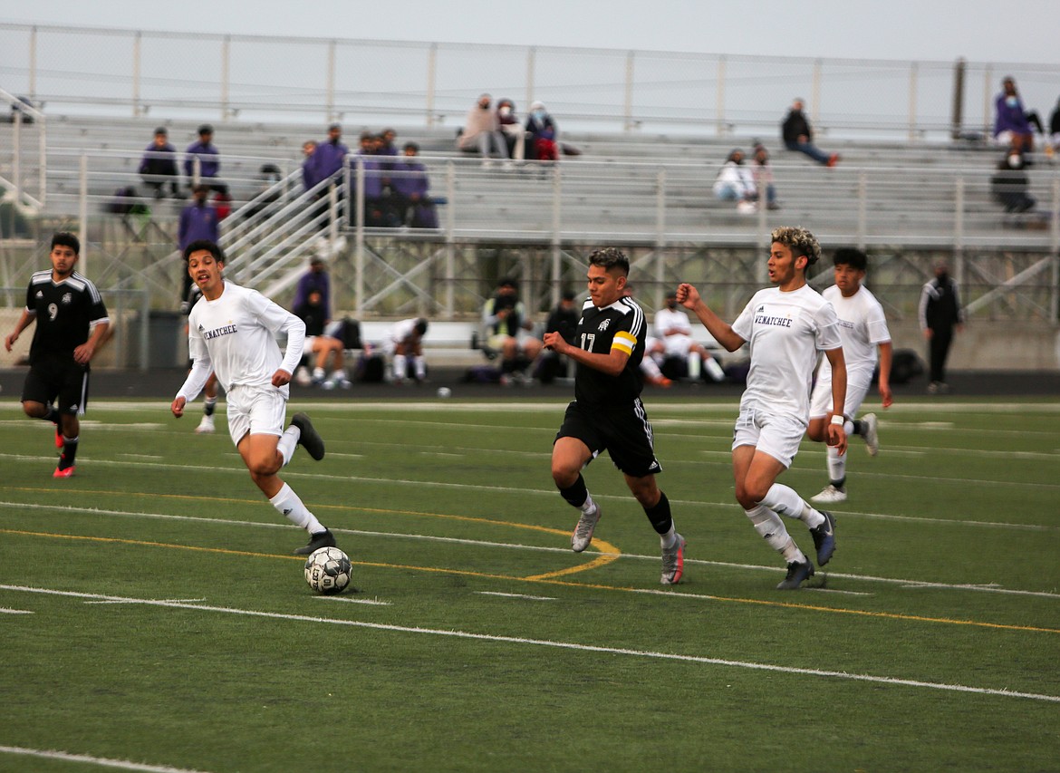 Royal High School's Eliseo Romero sprints toward goal with Wenatchee players in pursuit in the second half on Friday night at Royal High School.
