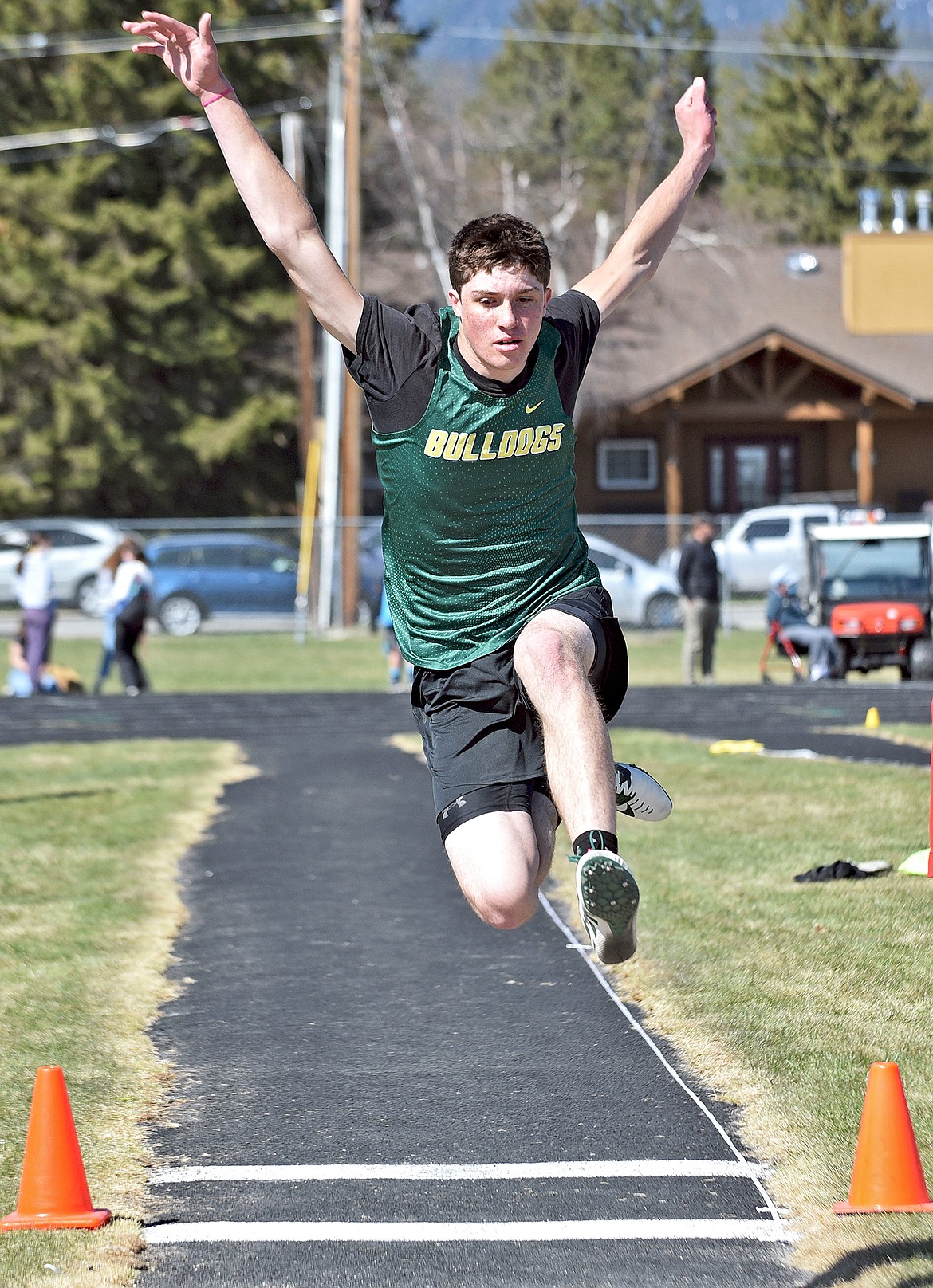 Whitefish's Morgan Kyle takes a big leap in the long jump event at Whitefish High School on Tuesday, April 20. (Whitney England/Whitefish Pilot)