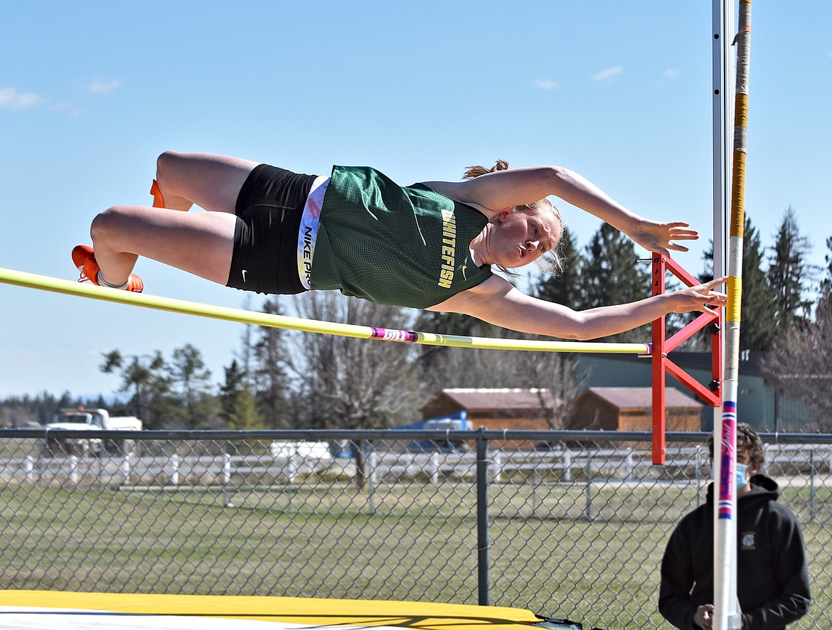 Lady Bulldog Norah Schmidt soars over the bar while competing in the pole vault event at Whitefish High School on Tuesday, April 20. (Whitney England/Whitefish Pilot)