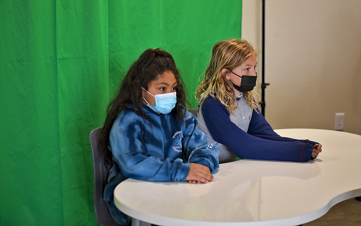 Muldown News anchors Audrey Jones and Elijah Walrath deliver the news of the day which is recorded via tablet and then uploaded to the school website to be shown in every classroom the following morning. (Whitney England/Whitefish Pilot)