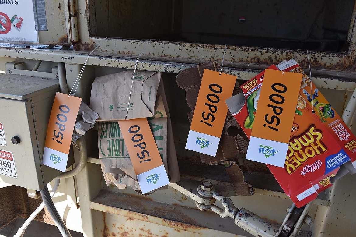 The WasteNot Project last week for Earth Day placed “oops tags” on recycling bins at Flathead County green box sites to alert folks to items that they might be placing in recycling bins incorrectly. (Heidi Desch/Whitefish Pilot)