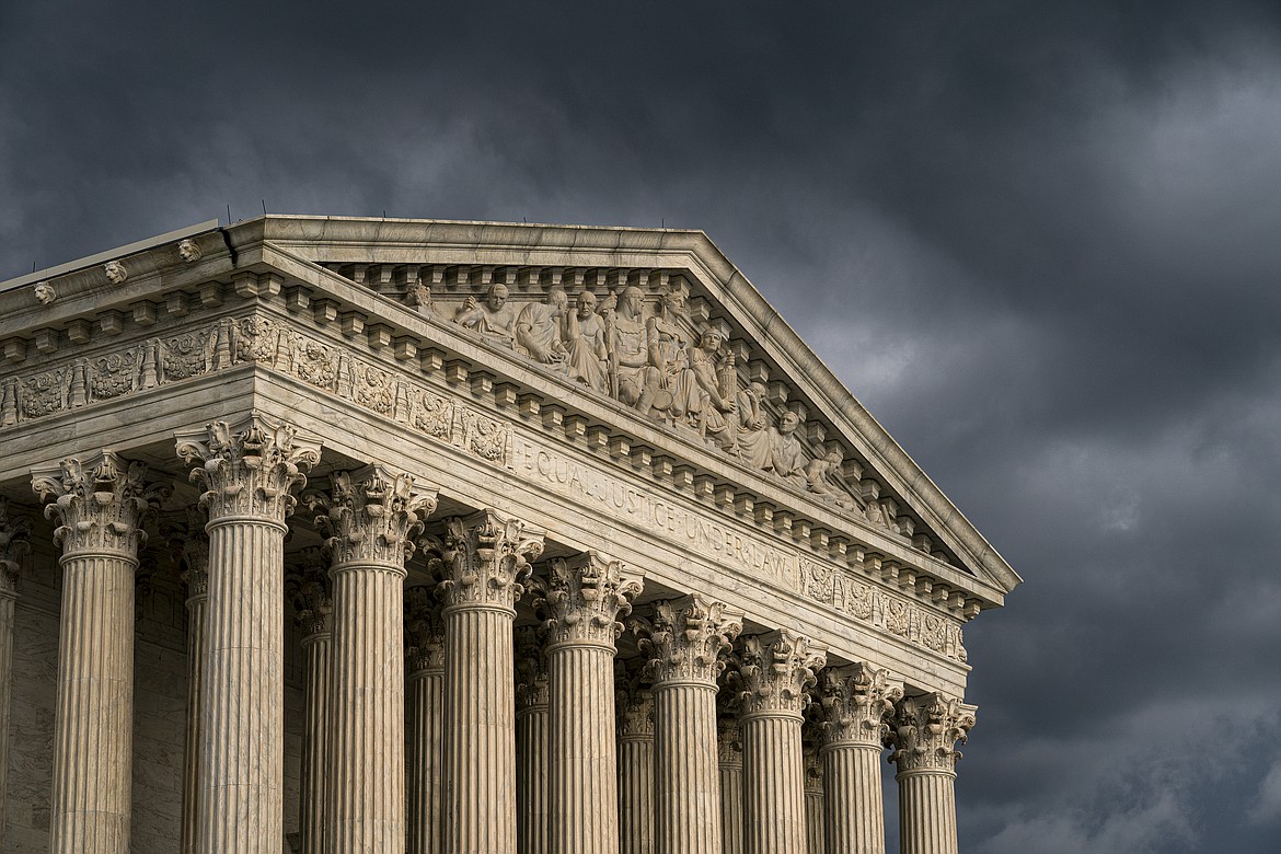 In this June 20, 2019, file photo, the Supreme Court is seen in Washington as a storm rolls in. The Supreme Court has agreed to hear an appeal to expand gun rights in the United States in a New York case over the right to carry a firearm in public for self-defense.