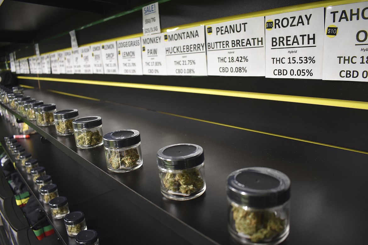 In this Nov. 11, 2020 file photo Jars of marijuana are seen on display at Montana Advanced Caregivers, a medical marijuana dispensary, in Billings, Mont. The Montana Senate on Friday, April 23, 2021, passed a bill to implement a recreational marijuana program in the state, which would reserve tax revenue from sales for addiction treatment and statewide conservation efforts. (AP Photo/Matthew Brown, File)