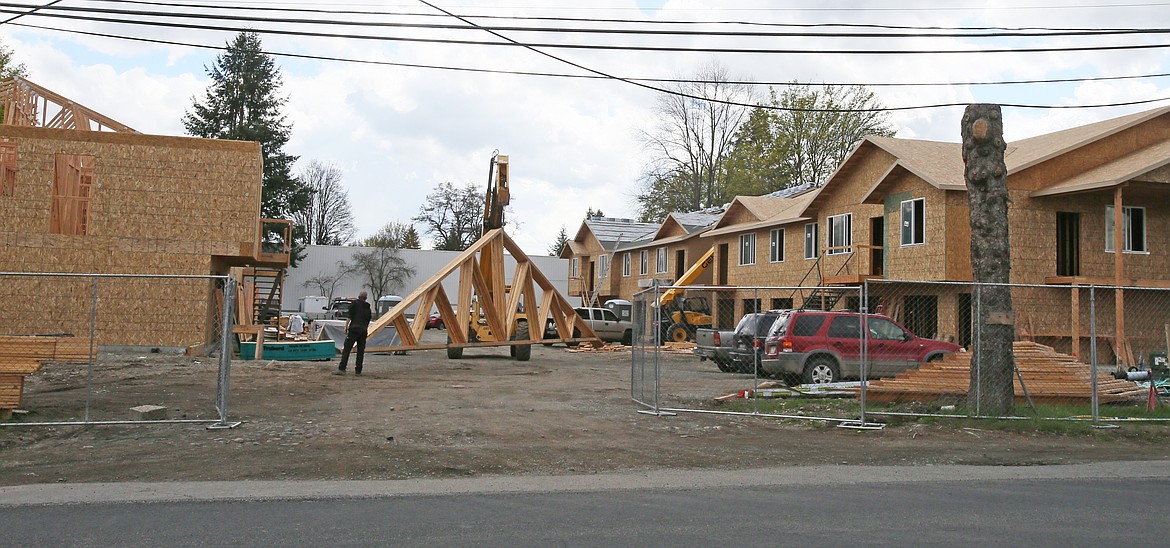 Construction continues to swell throughout Kootenai County, including this multi-family project on Hayden Avenue near Capone's in Hayden. The land crunch, skyrocketing housing prices and the escalating demand for public services has sparked a new regional partnership to explore solutions to the local growth crisis. (DEVIN WEEKS/Press)