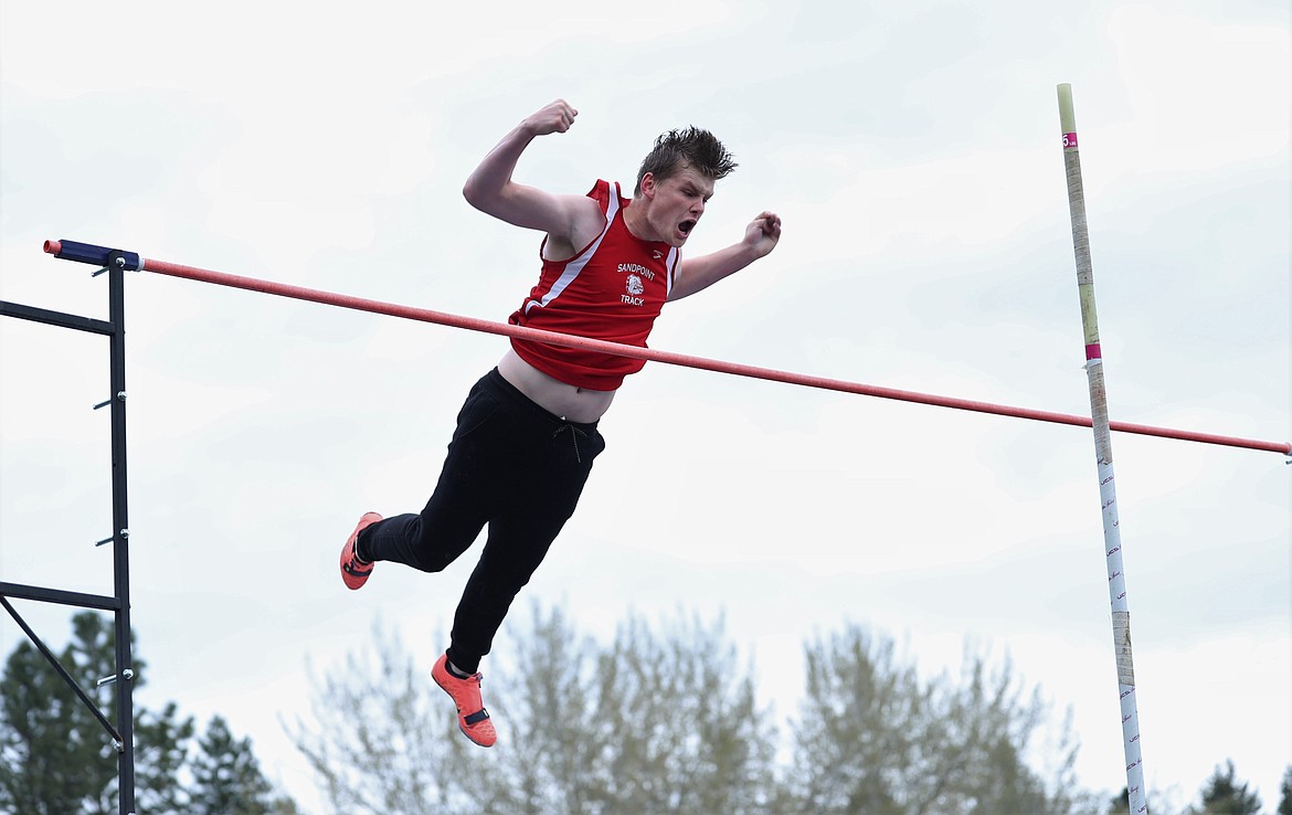 Senior Nate Dotson celebrates in midair after clearing 12 feet, 6 inches in the pole vault on Saturday.