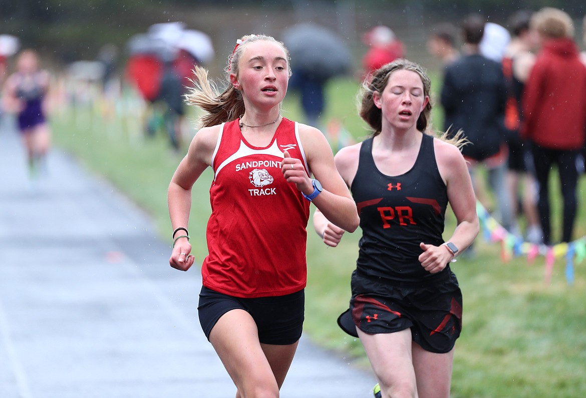 Grace Rookey (left) passes Priest River's Annika Rantala in the 1600 on Saturday.