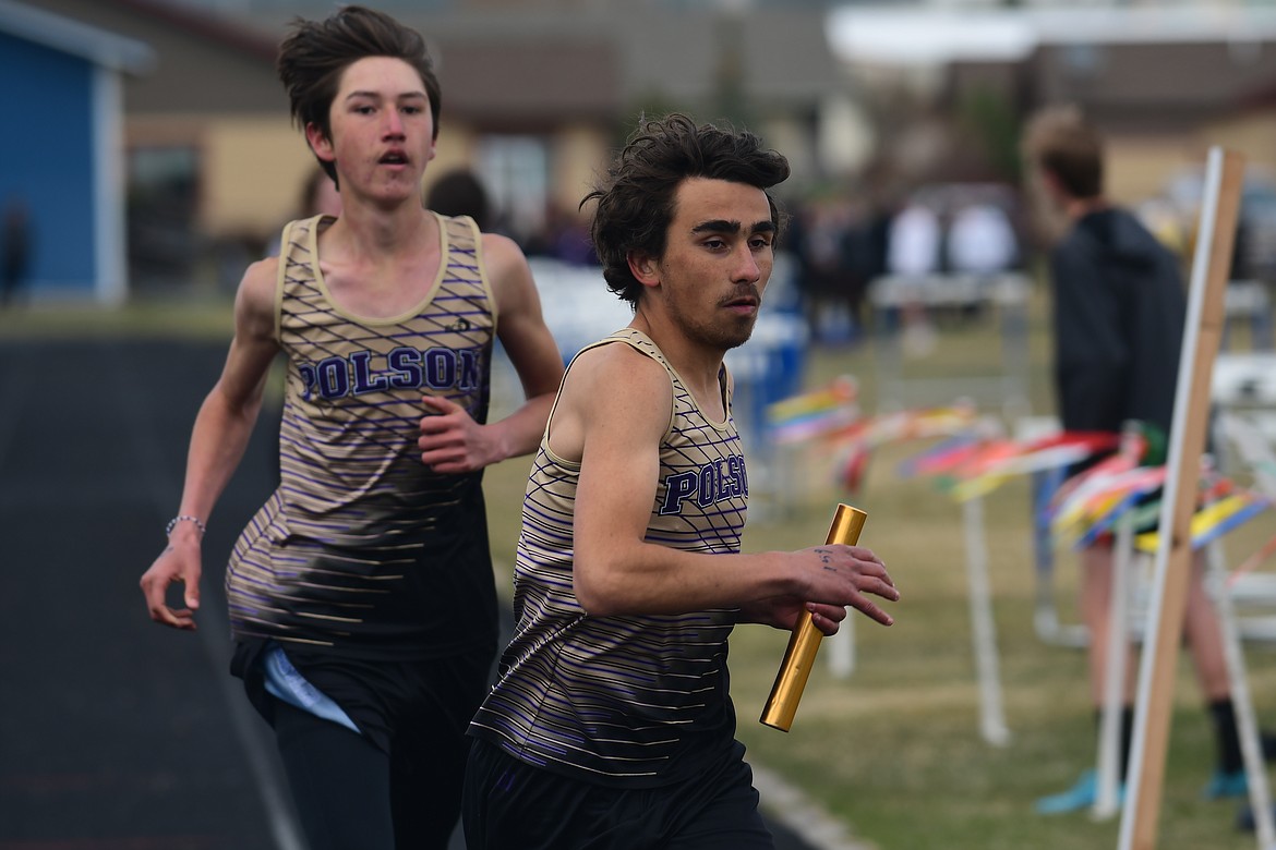 Polson's Hayden Clairmont hands off to Ryan Dupuis during a relay event at Columbia Falls.(Teresa Byrd/Hungry Horse News)