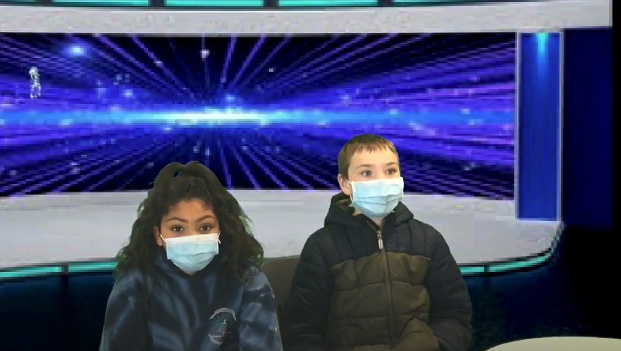 The students utilize green screen technology to appear as if they are reporting live from a real news station. Pictured is Audrey Jones and Hudson Clark.