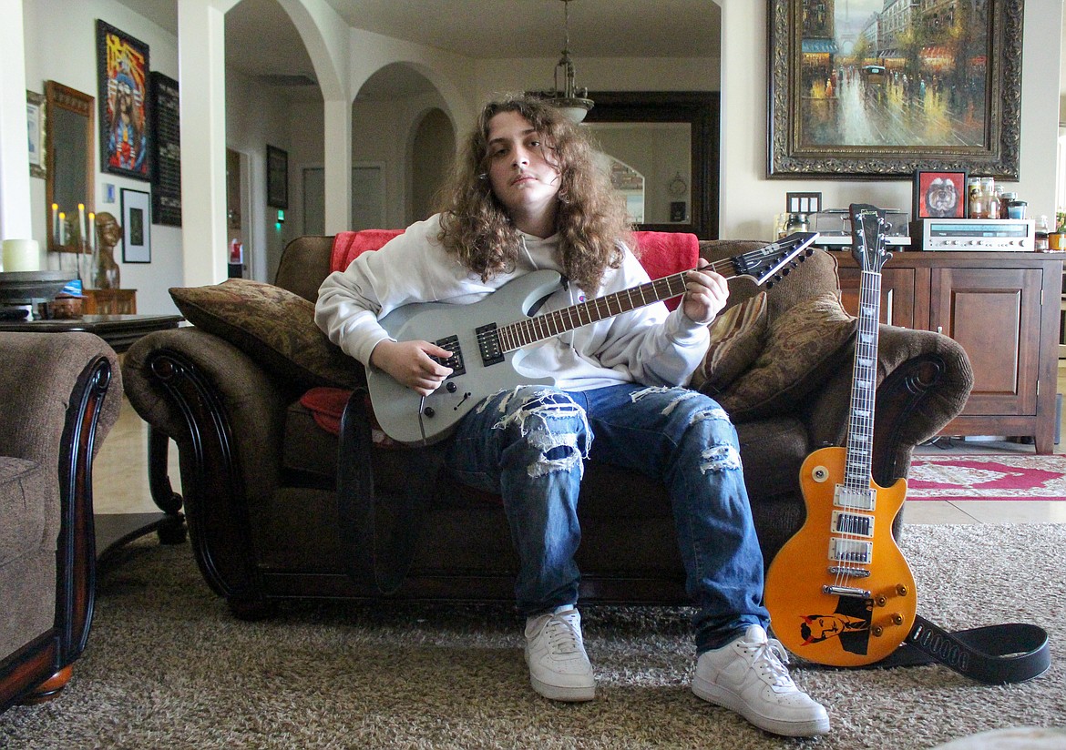 Gunnar Rimple, a high school freshman in Moses Lake, holds his guitar in hand on Tuesday afternoon which he hopes will help launch him toward his dreams of rock 'n' roll fame.