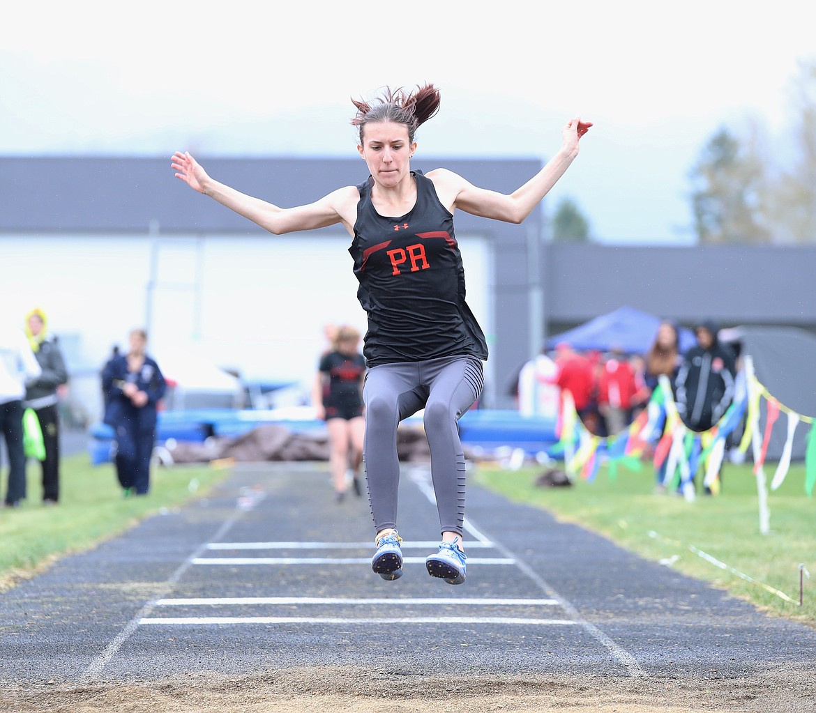 Alyssa Clement leaps into the pit in the long jump.