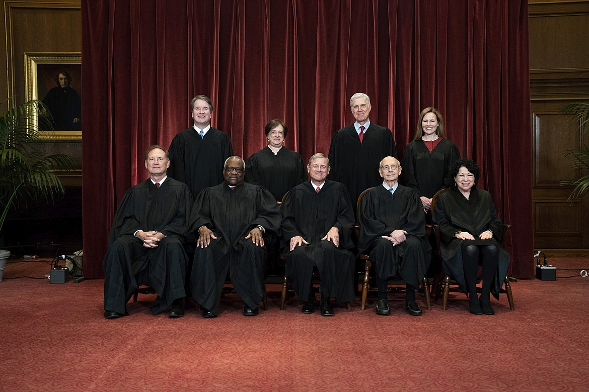 In this April 23, 2021, file photo members of the Supreme Court pose for a group photo at the Supreme Court in Washington. Seated from left are Associate Justice Samuel Alito, Associate Justice Clarence Thomas, Chief Justice John Roberts, Associate Justice Stephen Breyer and Associate Justice Sonia Sotomayor, Standing from left are Associate Justice Brett Kavanaugh, Associate Justice Elena Kagan, Associate Justice Neil Gorsuch and Associate Justice Amy Coney Barrett. Before the Supreme Court this is week is an argument over whether public schools can discipline students over something they say off-campus.