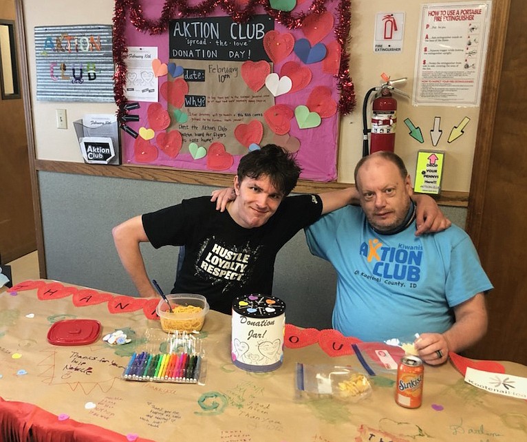 Aktion Club Chairman Robert McRae and treasurer Justin Moore man the donation table at Tesh on Feb. 10 as they collect change to buy a "thank-you" gift card for Kootenai Health housekeeping staff.