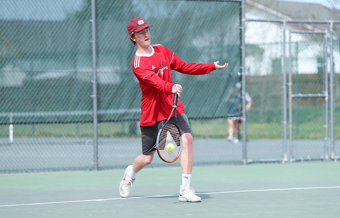 Charlie Johnson returns a shot on Thursday.