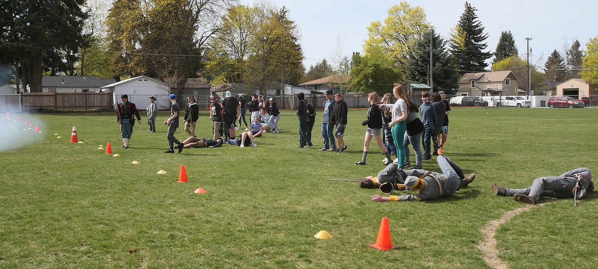 Students and Civil War reenactors collapse after a cannon blast rips through campus at Lakes Middle School on Thursday. No projectile was shot, but the sound rumbled throughout the neighborhood and gave kids a good idea of how loud Civil War artillery really was.