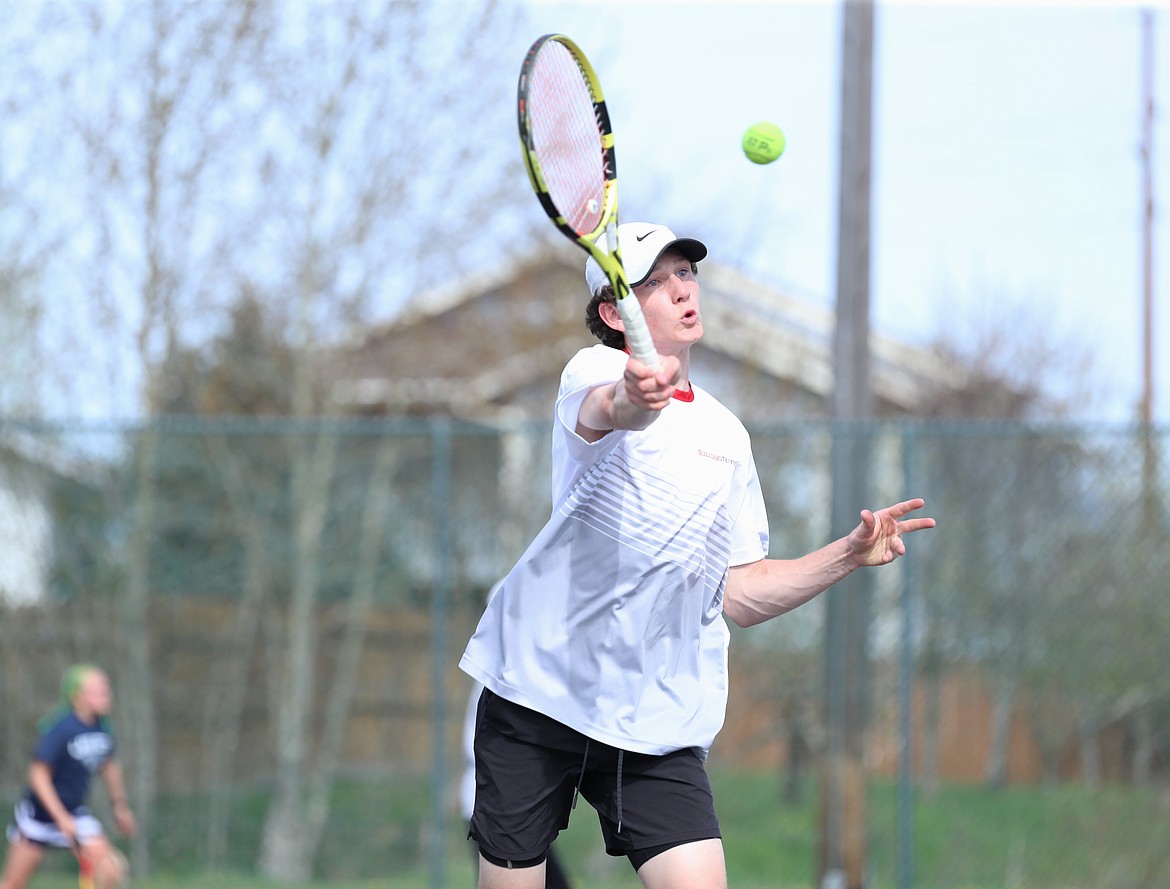 Josh Embree drives toward the net and hits a volley on Thursday.