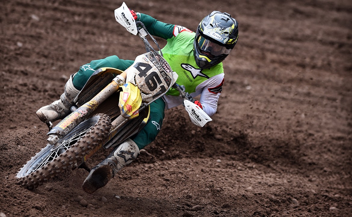 Open pro division winner Thomas Richards slides through a sharp turn on the Hungry Horse motocross track April 24. (Jeremy Weber/Daily Inter Lake)