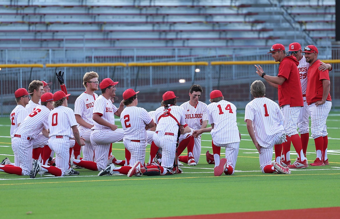 Head coach Chase Tigert talks to the team following Thursday's doubleheader against Lewiston.